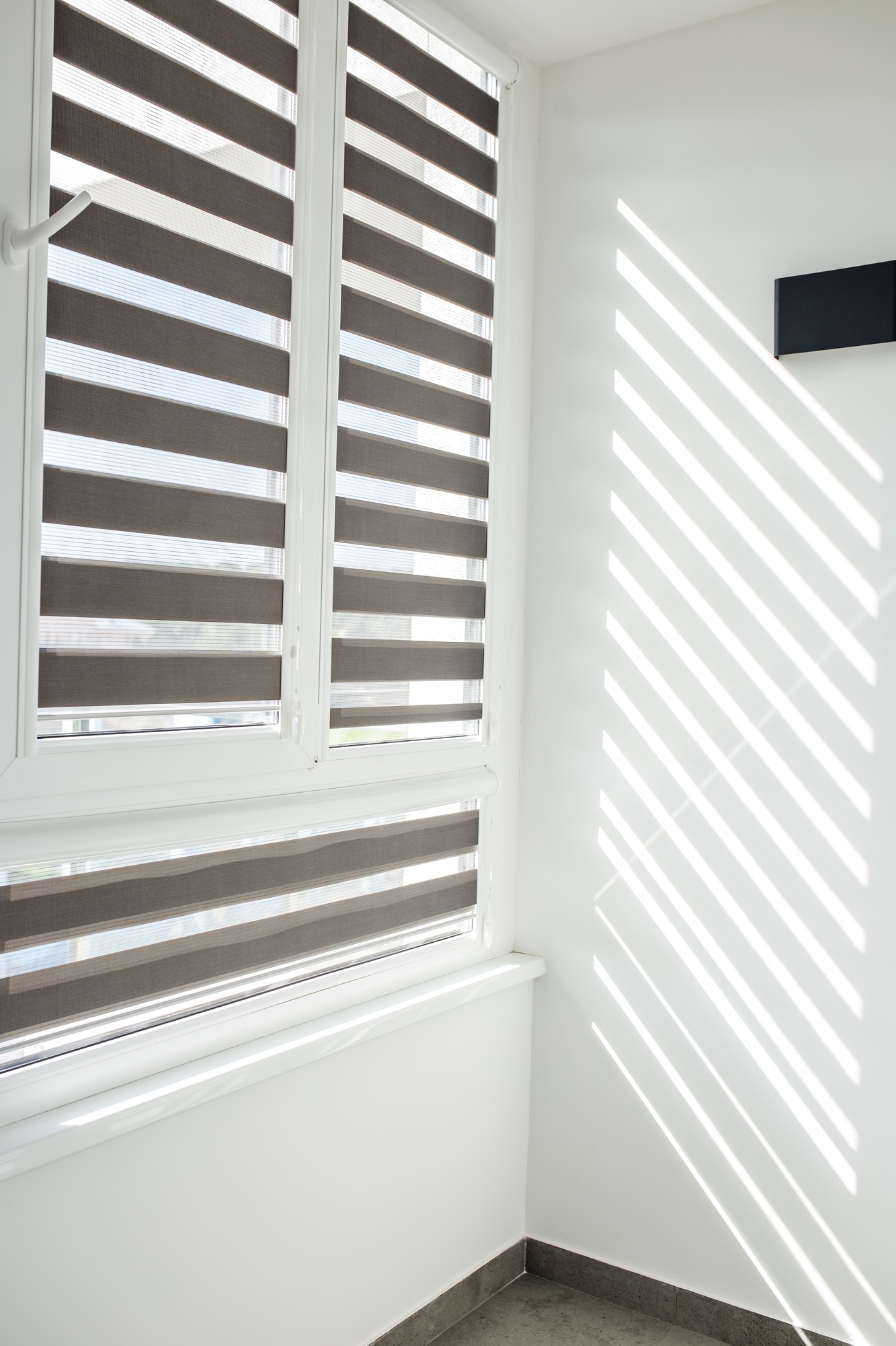 Roller blinds on balcony windows. Beautiful window blinds, sun protection